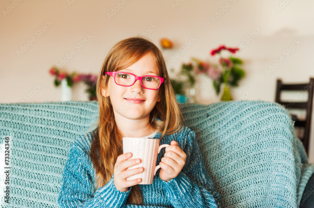 Indoor portrait of a cute little girl resting on a sofa Indoor portrait of a cute little girl resting on a sofa