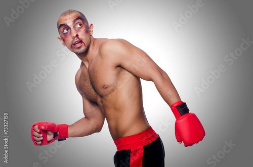 Badly beaten boxer isolated on white © Elnur