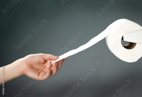 Grabbing the toilet paper.