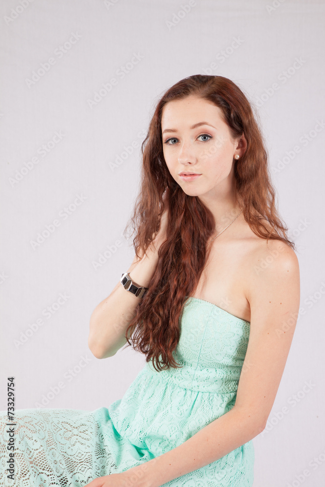 Woman looking thoughtfully at the camera, hand in her hair Woman looking thoughtfully at the camera, hand in her hair