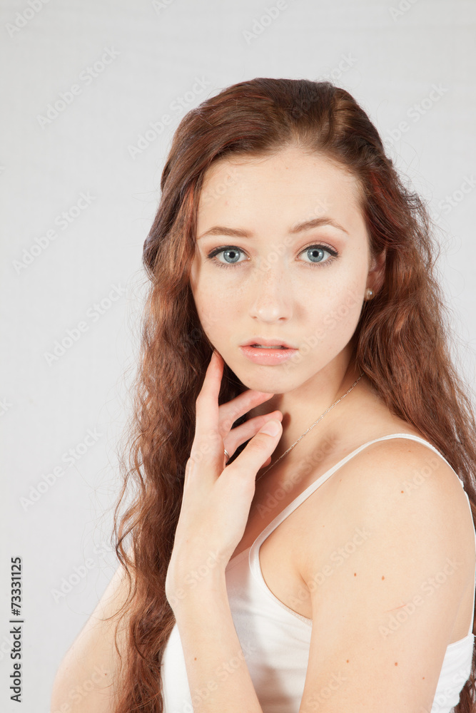 Woman with long hair looking thoughtfully at the camera Woman with long hair looking thoughtfully at the camera