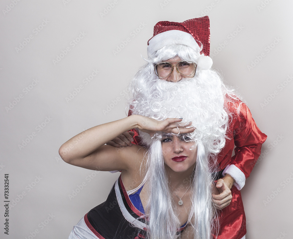 Santa Claus and girl playing with his beard