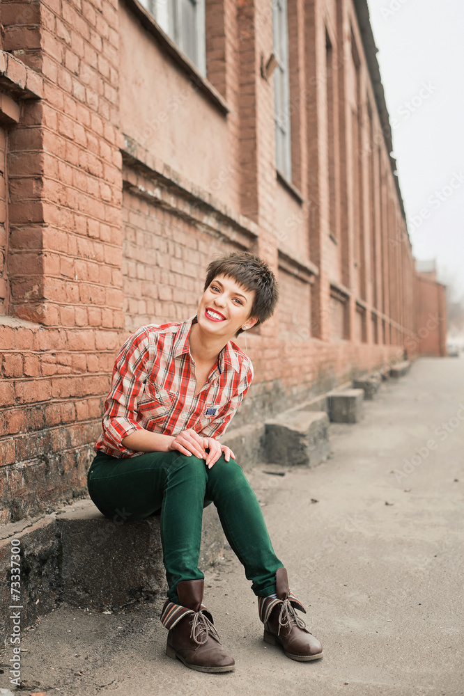 Woman wearing checkered shirt and jeans. Short hair Woman wearing checkered shirt and jeans. Short hair