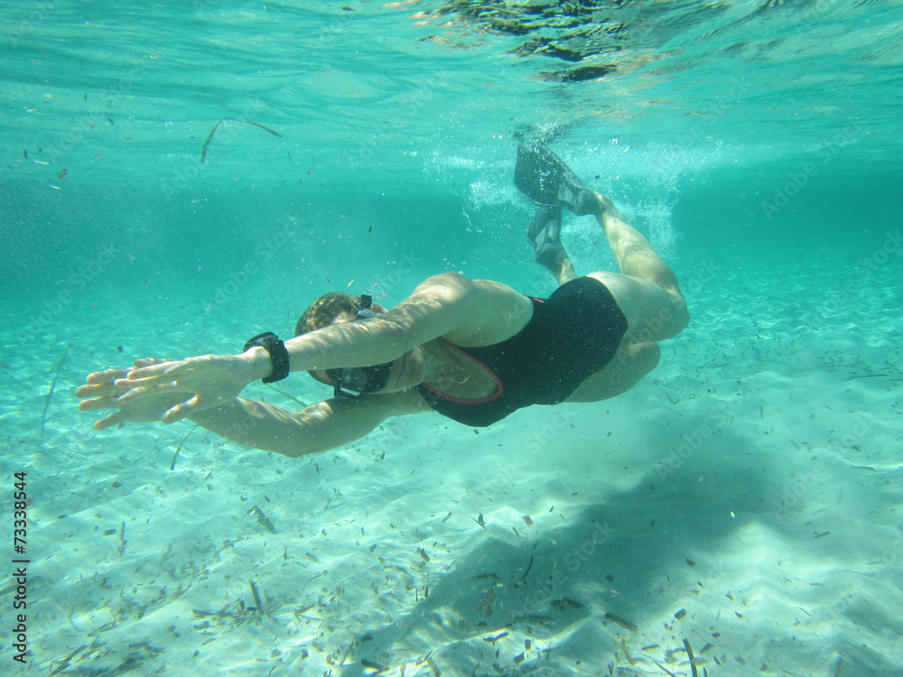Female swimmer diving underwater
