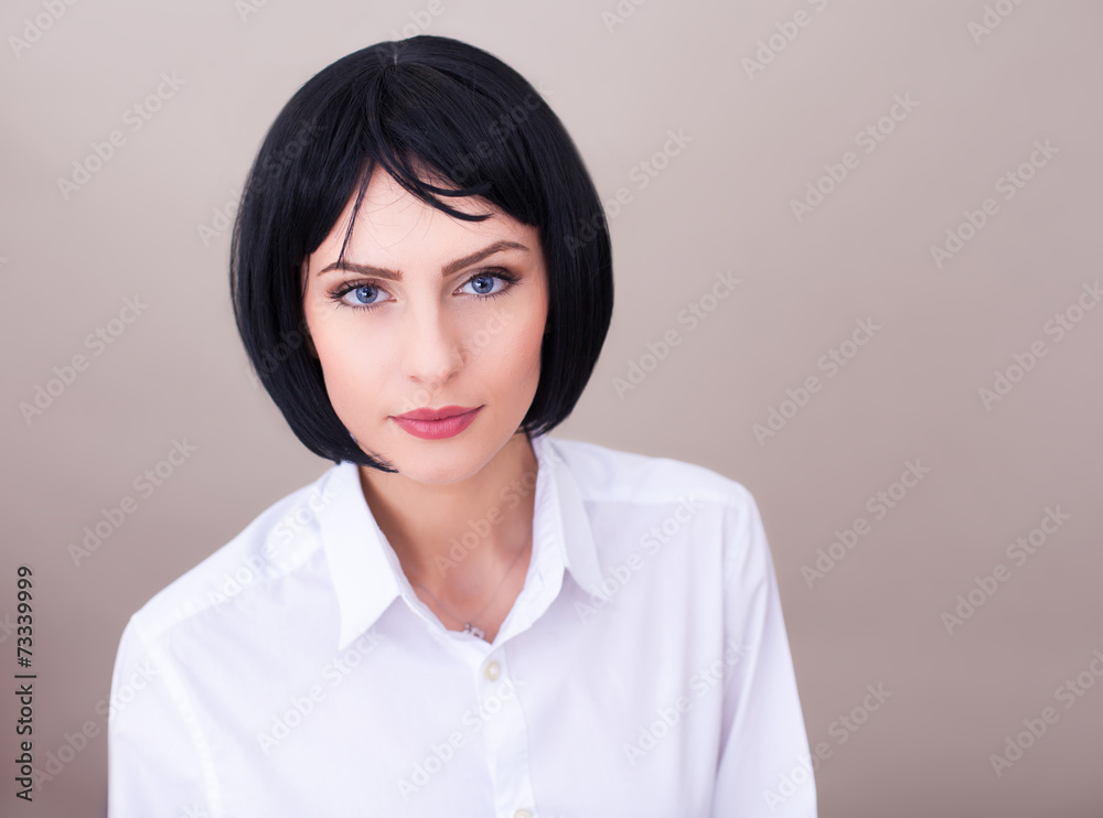 brunette woman with blue eyes in white shirt isolated