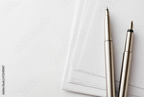 Pens and Blank Papers on Top of White Table