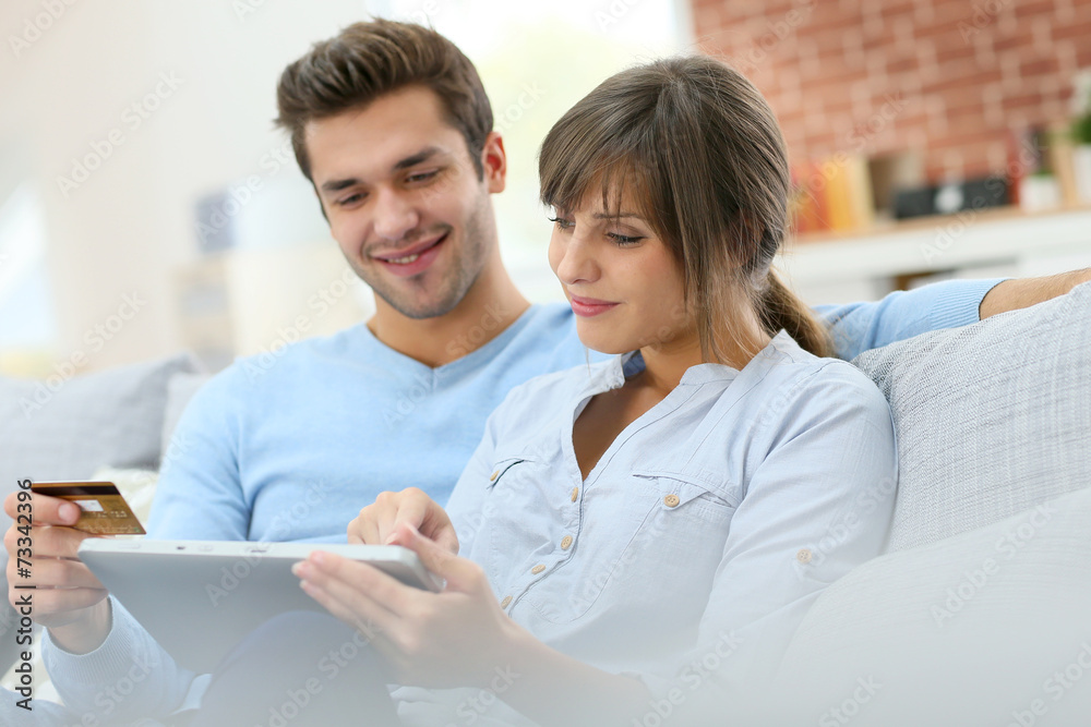 Young couple shopping on internet with tablet Young couple shopping on internet with tablet