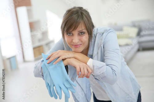 Young housekeeper standing with mopping equipment