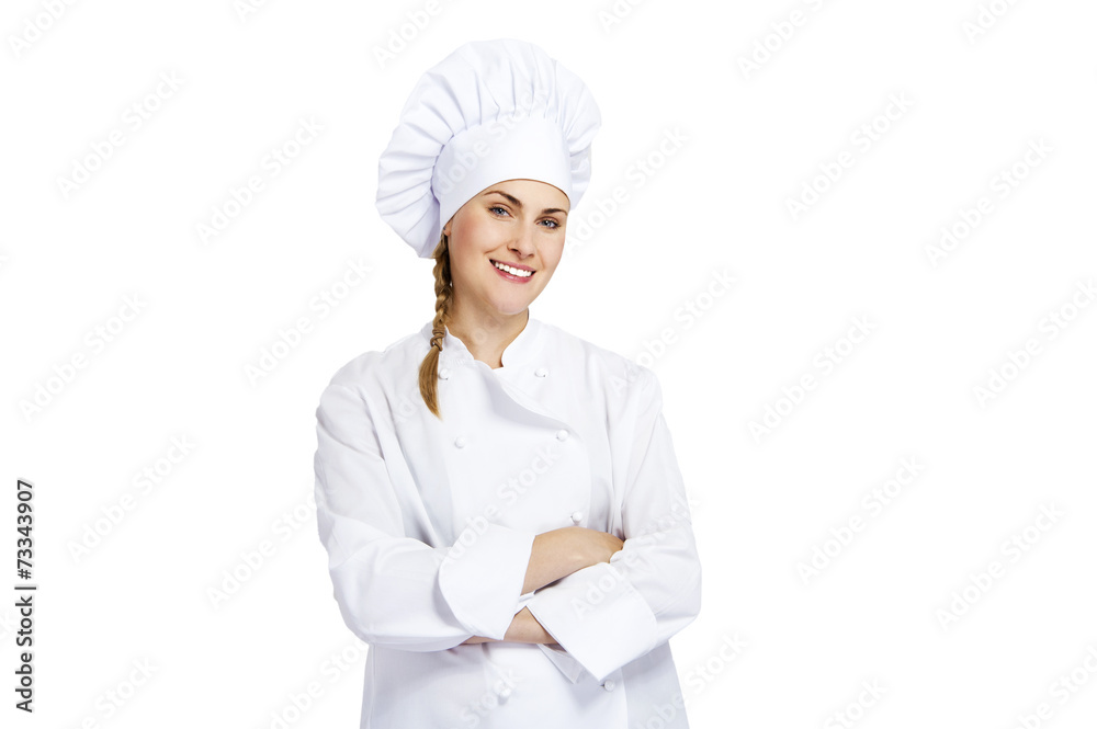 A young, female chef in a traditional hat and coat. A young, female chef in a traditional hat and coat.