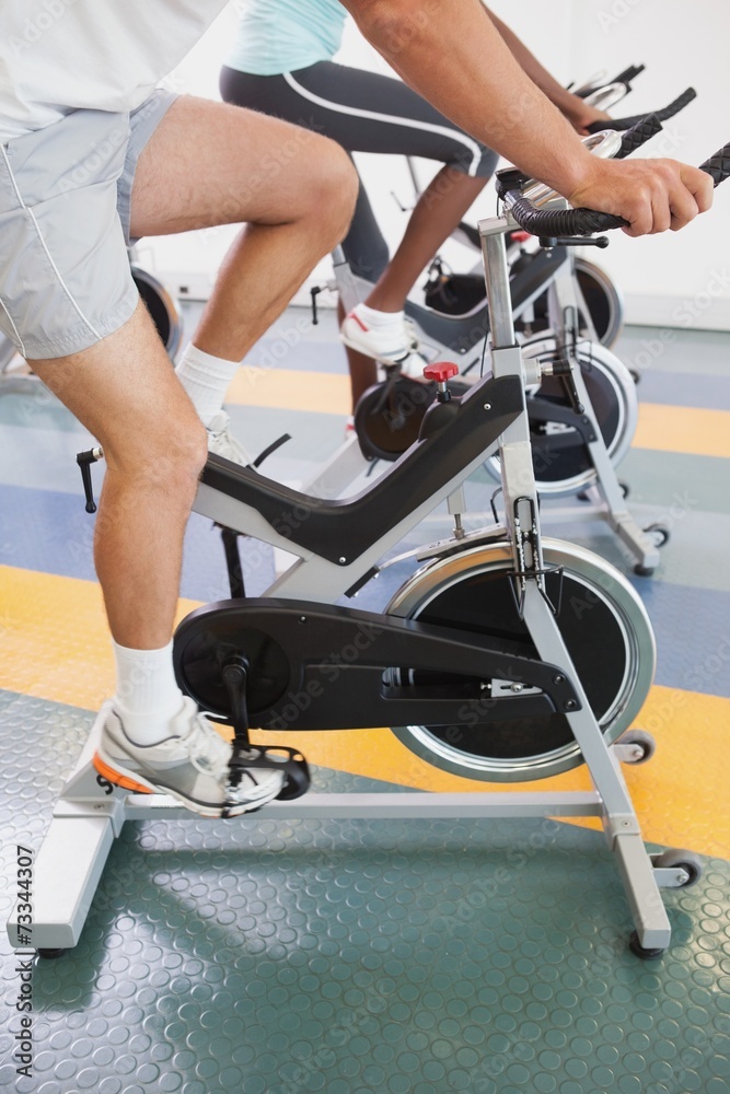 Fit people working out on the exercise bikes Fit people working out on the exercise bikes