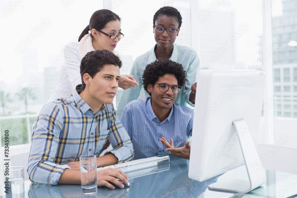 Casual business team working together at desk Casual business team working together at desk