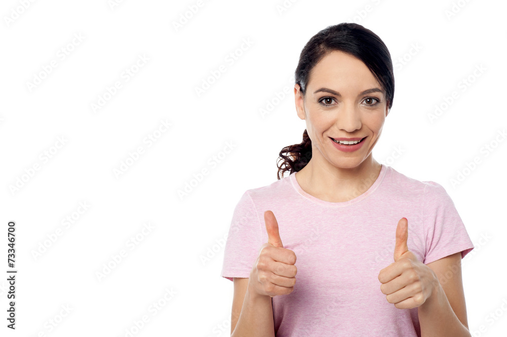 Smiling woman with thumbs up gesture Smiling woman with thumbs up gesture
