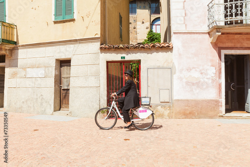 Woman on a bicycle through the streets of the country