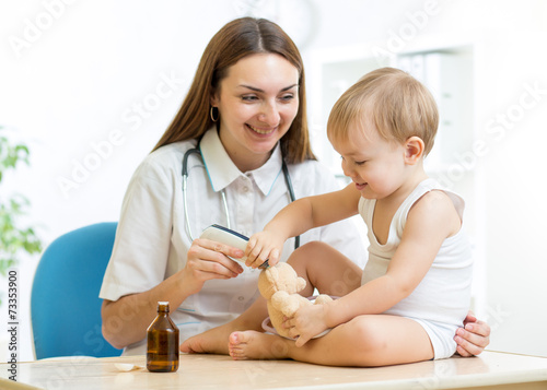 doctor examining happy child boy