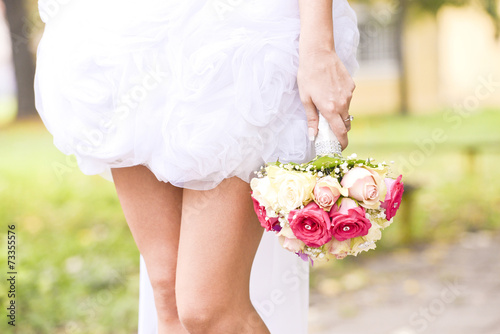 Young bride holding bouquet
