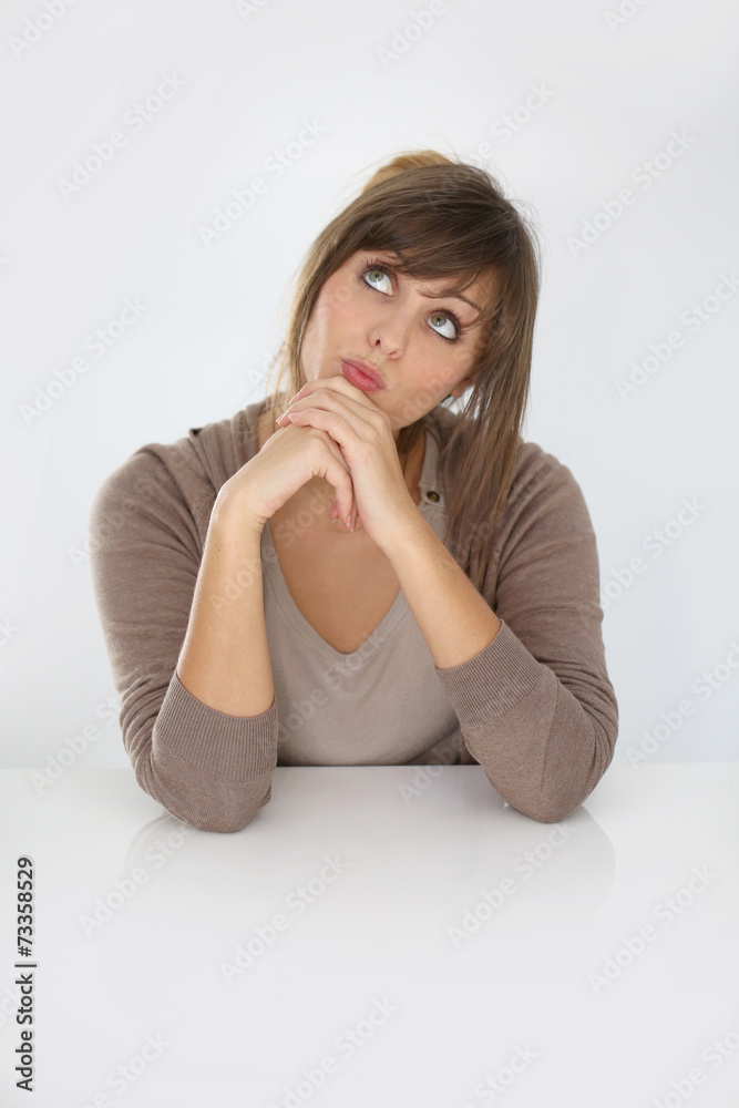 Young woman looking up and being thoughful, isolated Young woman looking up and being thoughful, isolated