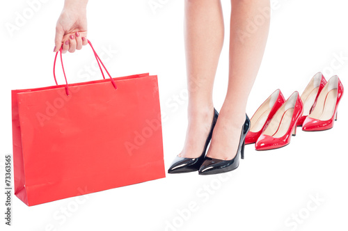 Business woman holding a red shopping paper bag
