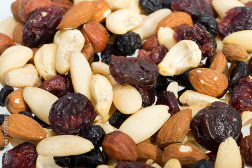 mixed nuts and dried fruits isolated on white background photo