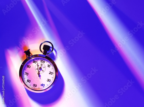 An overhead view of a sports stopwatch on a blue background