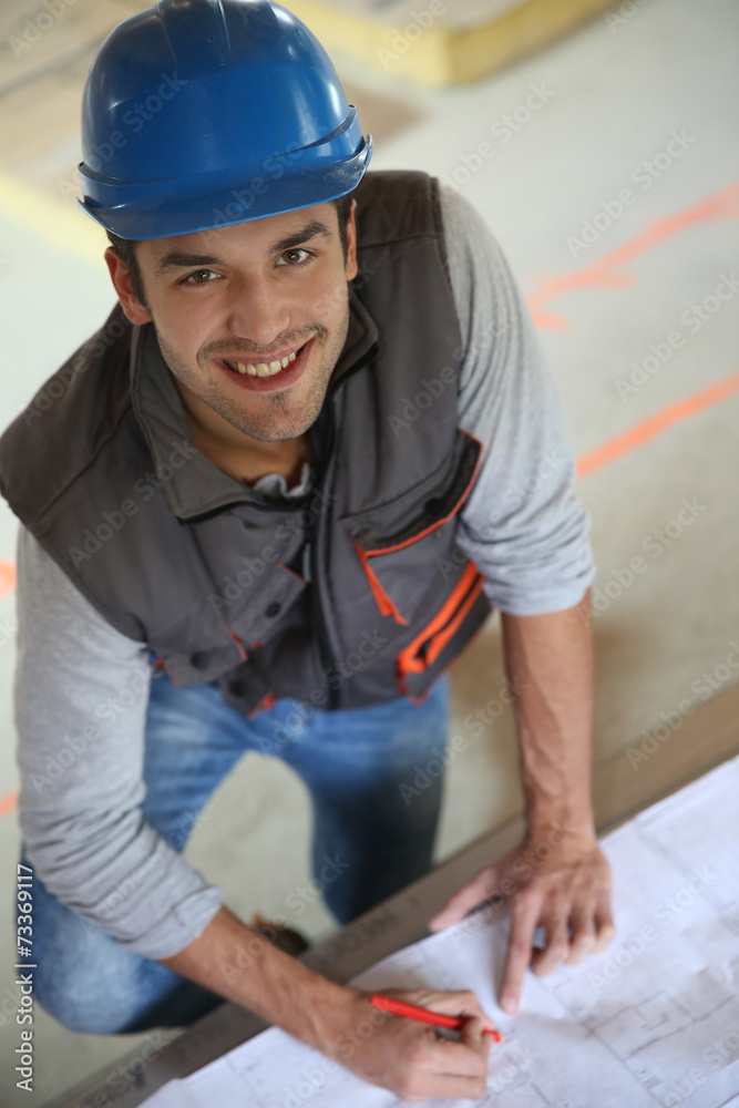 Construction worker checking blueprint Construction worker checking blueprint