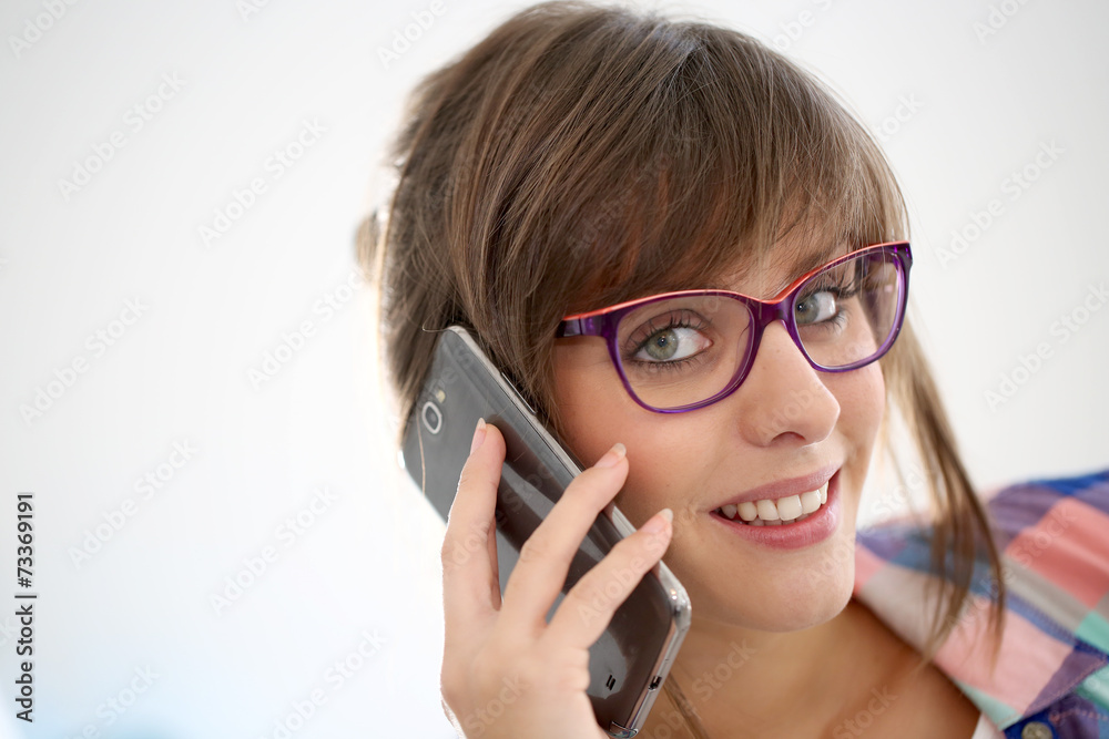 Cheerful girl with eyeglasses talking on phone Cheerful girl with eyeglasses talking on phone