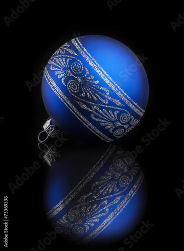 Blue Christmas ball on black background with reflection