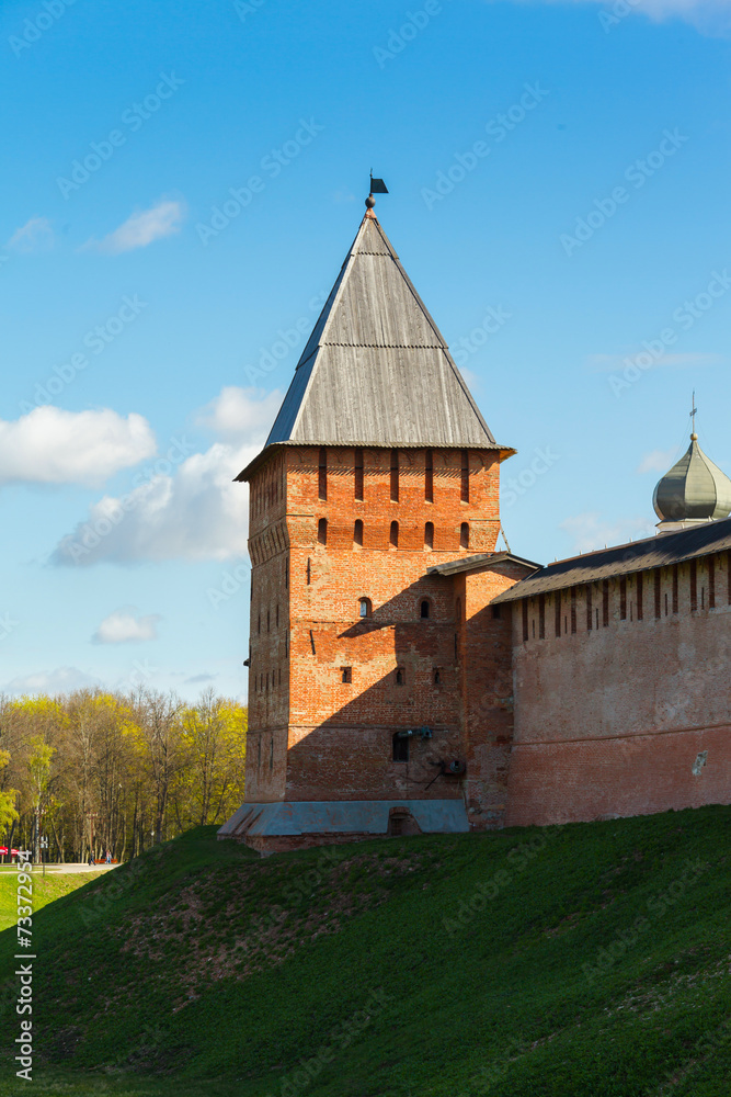Fortress tower of red brick and wall
