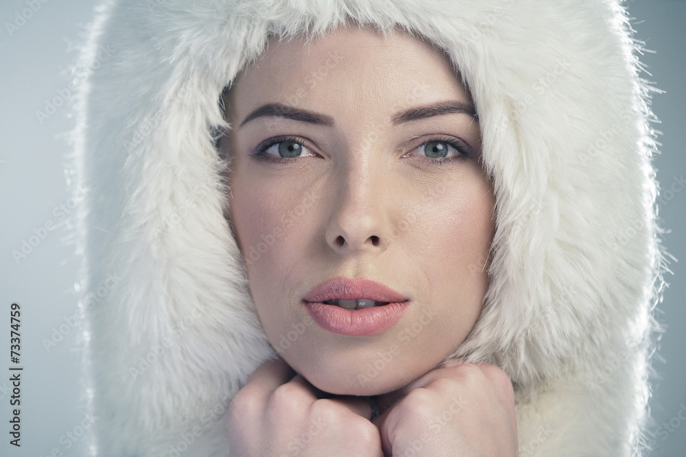 Young woman wearing a white fur cap