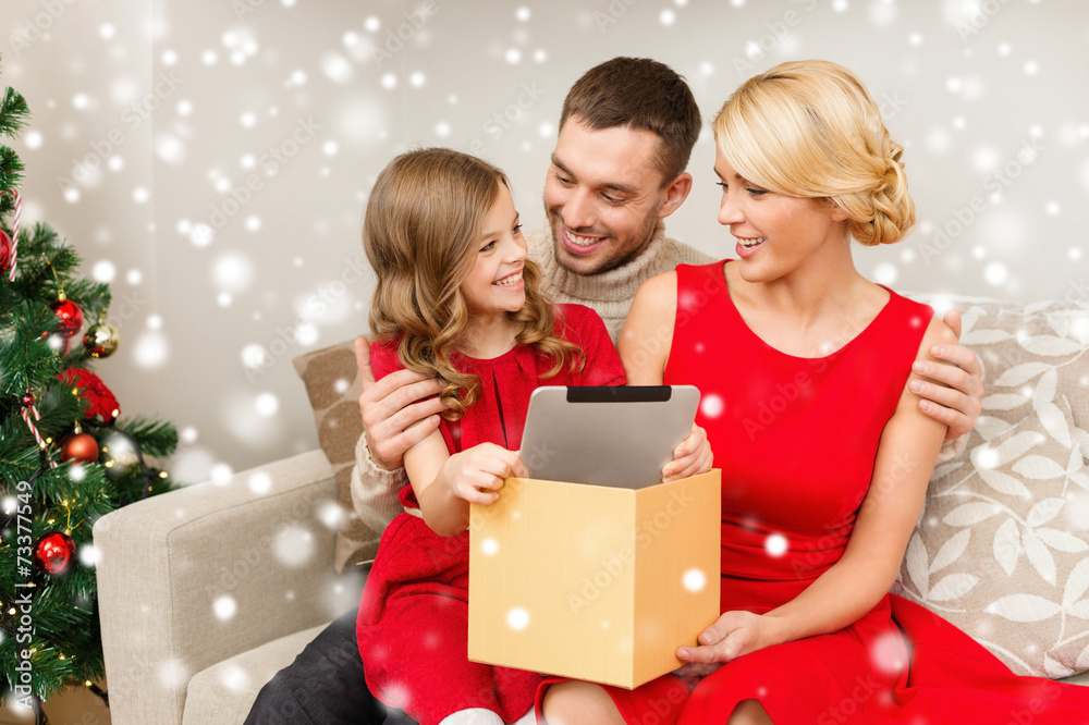 smiling family taking tablet pc out from gift box smiling family taking tablet pc out from gift box