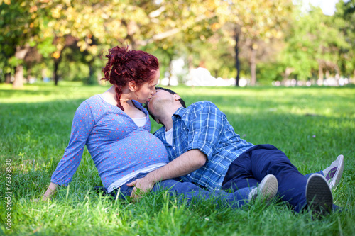 Pregnant couple relaxing in autumn park © taramara78