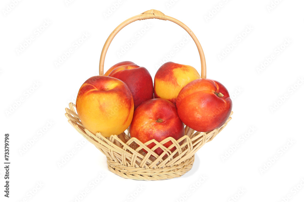 Nectarines in wicker basket isolated on white Nectarines in wicker basket isolated on white