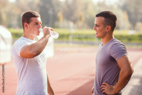 Two young athletes having a break during practice