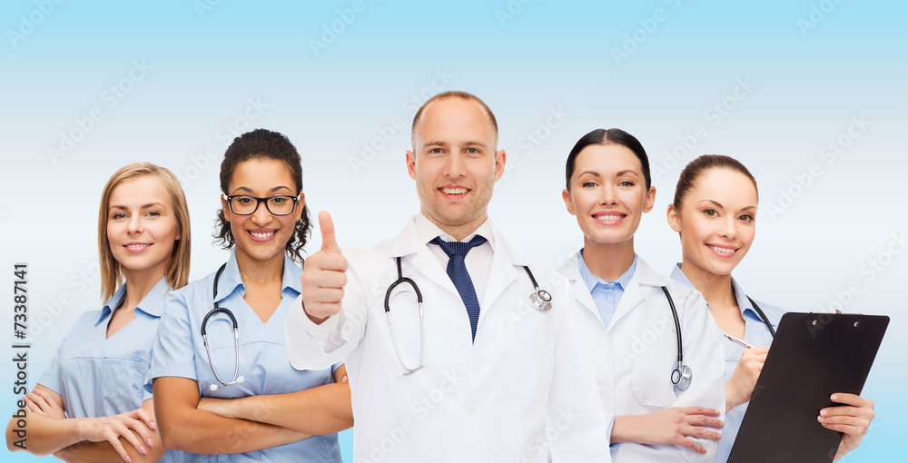 group of smiling doctors with showing thumbs up group of smiling doctors with showing thumbs up
