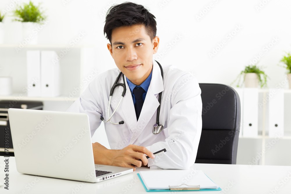 young asian doctor working with laptop in office young asian doctor working with laptop in office