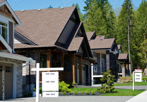 For sale signs in an upscale residential neighbourhood