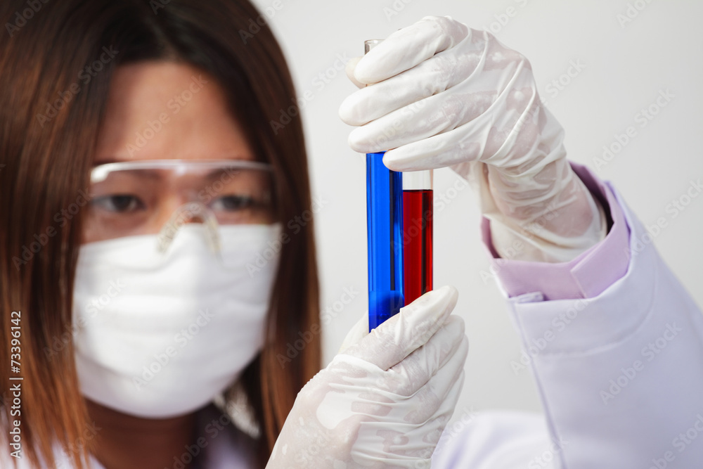 Naklejka premium Woman investigator checking test tubes.