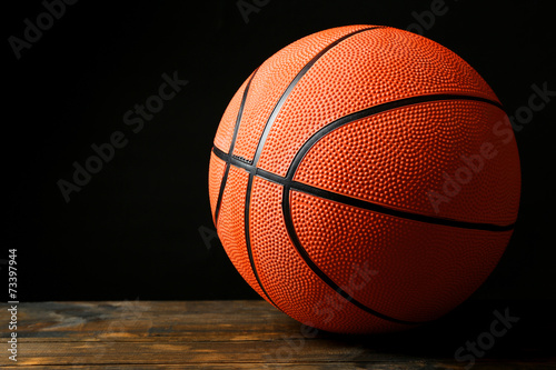 Basketball ball on black background © Africa Studio