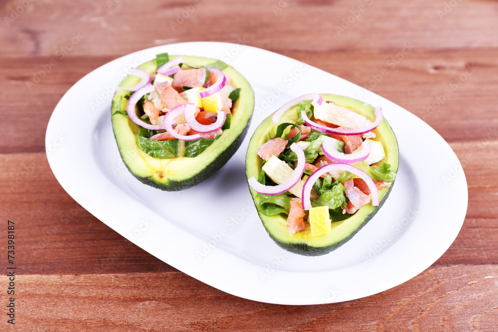 Tasty salad in avocado on plate table close-up Tasty salad in avocado on plate table close-up