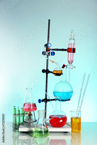 Laboratory glassware on light blue background