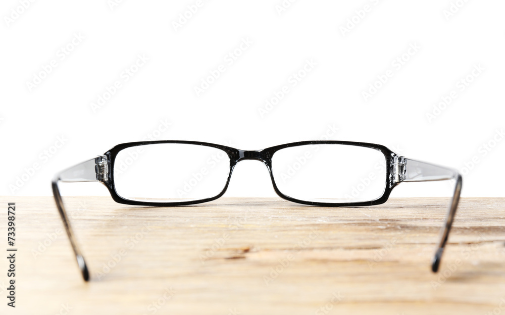 Eye glasses on wooden table on white background Eye glasses on wooden table on white background