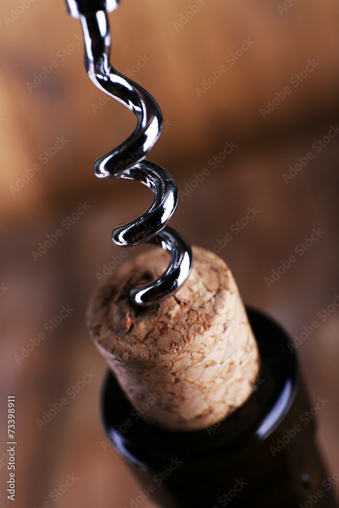 Bottle opener close-up, on wooden background Bottle opener close-up, on wooden background