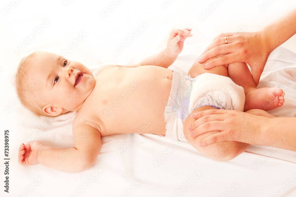 Baby massage. Mother massaging kid legs Baby massage. Mother massaging kid legs
