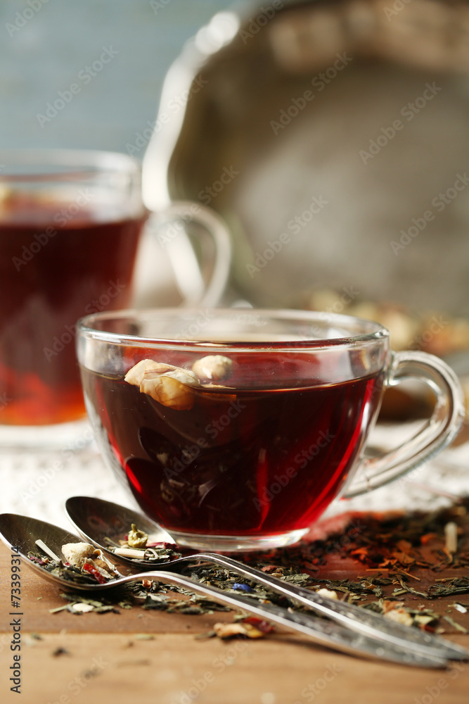 Fototapeta premium Beautiful vintage composition with herbal tea, on wooden table