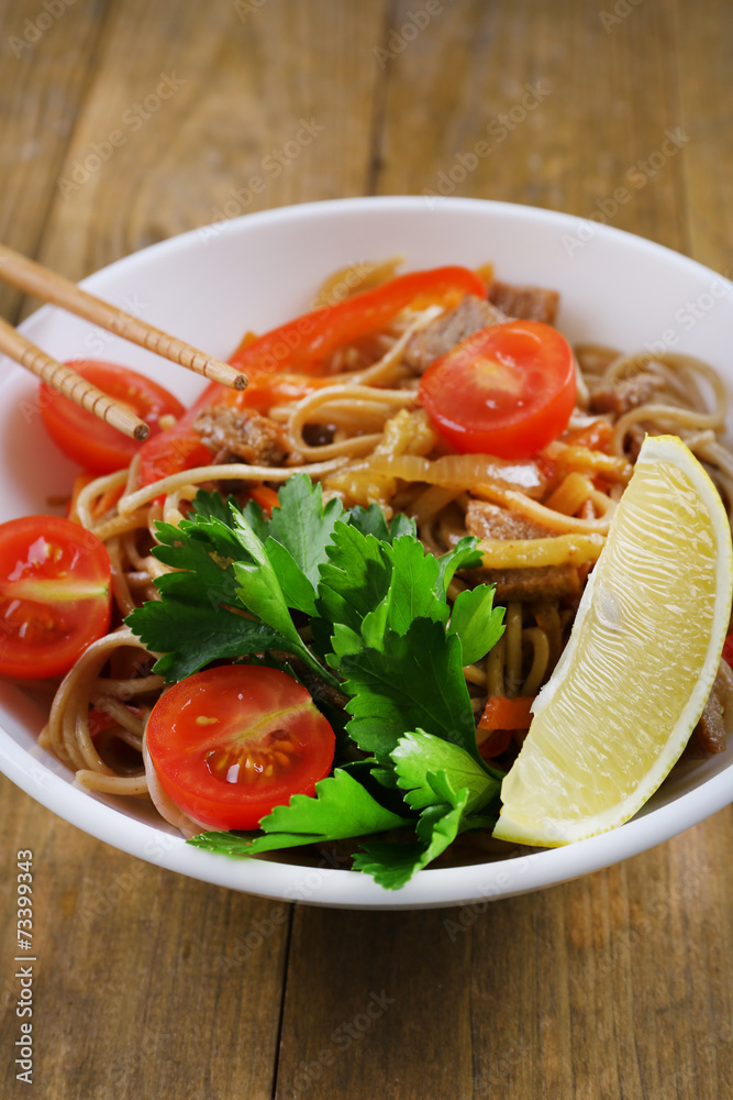 Chinese noodles with vegetables and roasted meat in bowl Chinese noodles with vegetables and roasted meat in bowl
