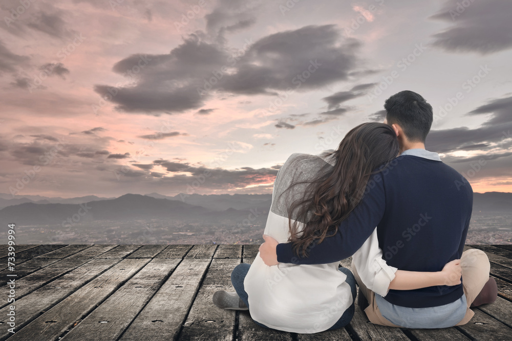 Fototapeta premium Asian young couple sit and hug together