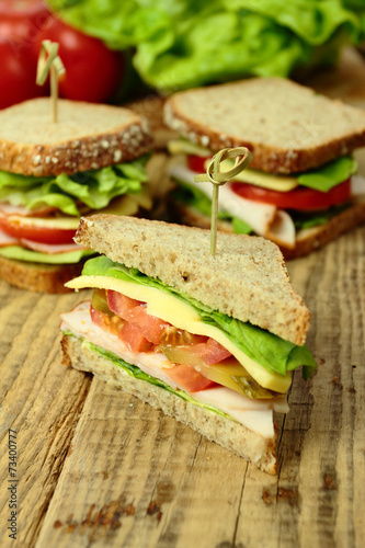 Tasty sandwiches with ham, cheese and fresh vegetables