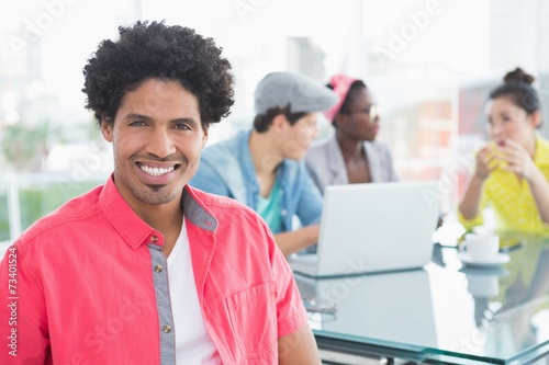 Young creative man smiling at camera