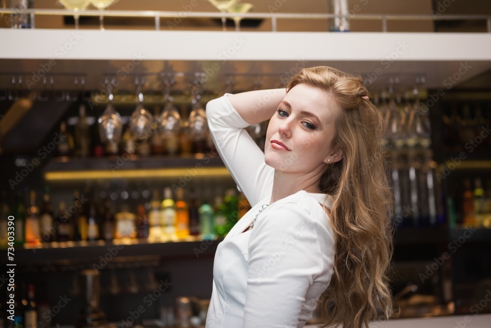 Pretty blonde girl in white dress posing hands in the hair Pretty blonde girl in white dress posing hands in the hair