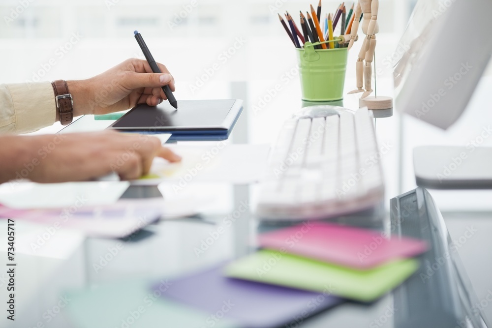 Designer working at desk using digitizer Designer working at desk using digitizer