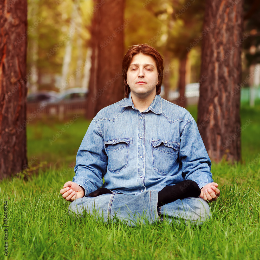 Young man meditating outdoors Young man meditating outdoors